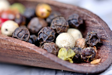 Poster - Wooden scoop with colorful peppercorns