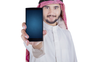 Wall Mural - Arabian person shows cellphone in studio