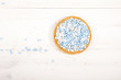 Traditional Dutch birth celebration biscuit with blue muisjes on wooden background