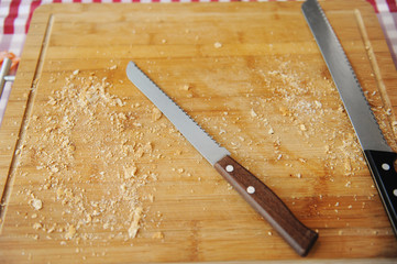 Two large bread knife on a cutting board