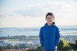 © gamelover - Young asian boy wearing jacket and smiling outdoor