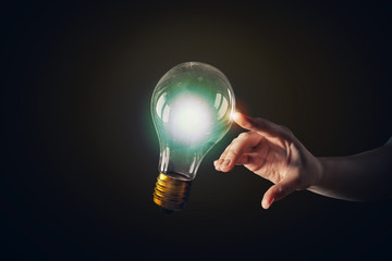 Wall Mural - hand pointing light bulb . mixed media
