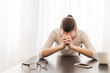 © kieferpix - Young woman sitting in her office feeling desperate. Praying and emotion concept.