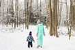 © satura_ - Happy family. Mother and child girl on a winter walk in nature.