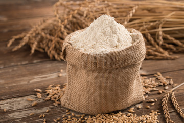 flour in bag on wooden table