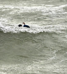 a surfer surf a wave in italy