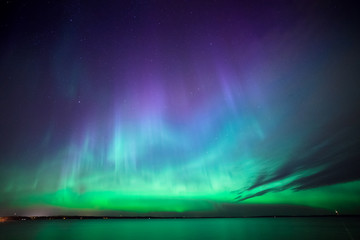 northern lights over lake in finland