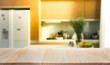 © hakinmhan - Wood table top island with blur kitchen room interior in morning