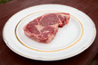 © Kondor83 - Rib eye steak on a rustic plate