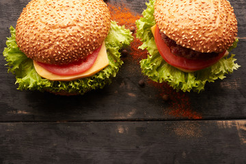 Two hamburger on a wooden table