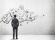 © ImageFlow - Businessman looking at startup icons and graphs on concrete wall