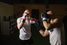 Two Boxer Practicing Boxing In Fitness Studio