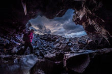 Woman Exploring Dewdrop Cave Craters Of The Moon National Idaho