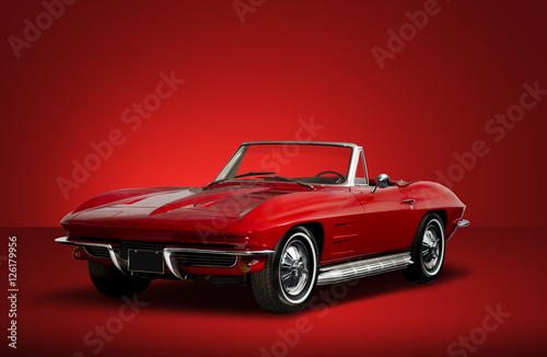 Fotografie, Obraz Red Vintage Convertible Automobile on Red Background