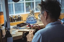 Craftswoman Working In Workshop