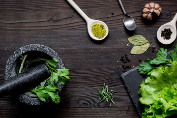 Wall Mural - garlic, fresh salad and spices on wooden background top view