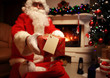 © opolja - Santa Claus brought gifts for Christmas and having a rest by the fireplace. Home decoration