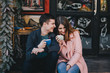 © polinaloves - Happy couple in warm clothes drinking coffee on a Christmas market. Holiday mood