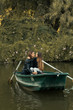 © Kike Arnaiz/ADDICTIVE STOCK - Couple embracing in boat in river.