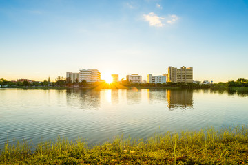 Canvas Print - Lake in city park with skyline in background