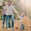 © chika_milan - Dad, mom and son flying a kite in nature
