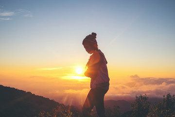 Silhouette Young Woman standing alone outdoor with wild forest m