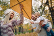 © chika_milan - Dad, mom and son flying a kite in nature