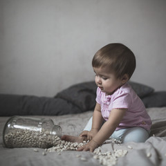 Wall Mural - baby playing on bed of beans, early  development, natural toys,