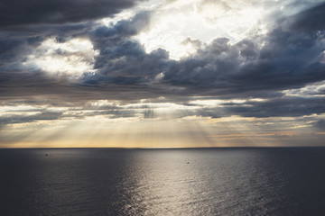 Clouds blue sky and sunlight sunset on horizon ocean . Сloudscape on background seascape dramatic atmosphere rays sunrise. Relax view waves sea with ship, mockup nature evening concept..