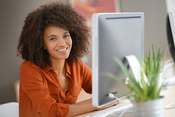 cheerful businesswoman working on desktop computer