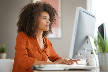 cheerful businesswoman working on desktop computer