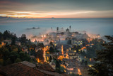 Fototapeta  - Bergamo through the fog at dawn