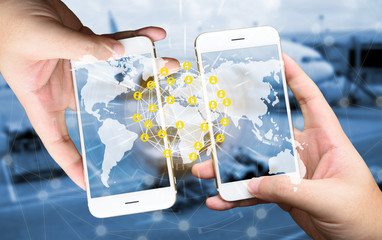 Two Businessman hands holding smartphones. Fintech concept , Peer-to-peer , logistic concept with map and world connect , airplane in airport blue background