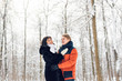 © satura_ - Young couple in love walking in the snowy forest