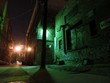 Creepy urban alley illuminated at night with graffiti
