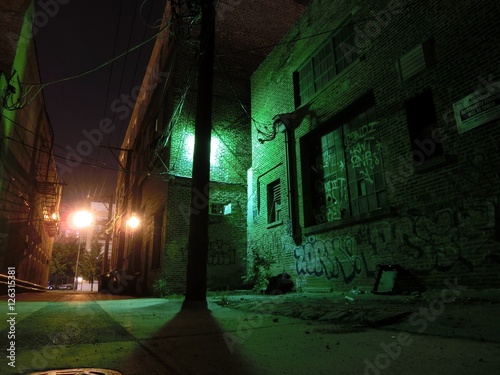 Fotografie, Obraz Creepy urban alley illuminated at night with graffiti
