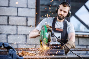 Industrial worker cutting metal