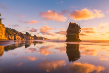 Sunset Rocky Beach Landscape, Three Sisters Rock Formation In Taranaki Region, New Zealand
