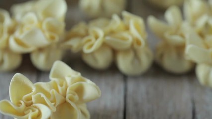 Wall Mural - Saccottini pasta shot with selective focus from a high angle. Saccottini are traditional Italian handmade pasta filled with prosciutto.