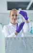 © Myvisuals - doctor female researcher holding up a test tube in labaratory