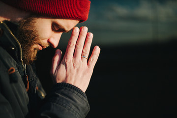 Man praying outside to God