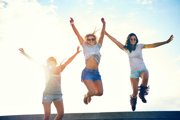 three joyful young women leaping in the air