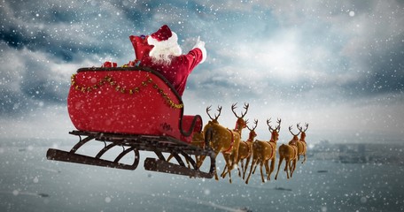 Wall Mural - Composite image of santa claus riding on sleigh during christmas