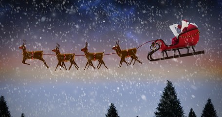 Poster - Composite image of side view of santa claus riding on sleigh dur
