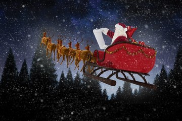 Poster - Composite image of santa claus riding on sled during christmas