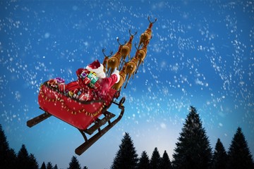 Poster - Composite image of high angle view of santa claus riding on sled