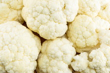 Raw Cauliflower On A Pile Forming Background