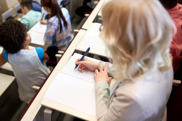 Canvas Print - student writing to notebook at exam or lecture