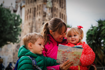 Family tourism - mother with kids travel in Barcelona