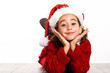 © javiindy - Adorable little girl wearing santa hat laying on wooden floor